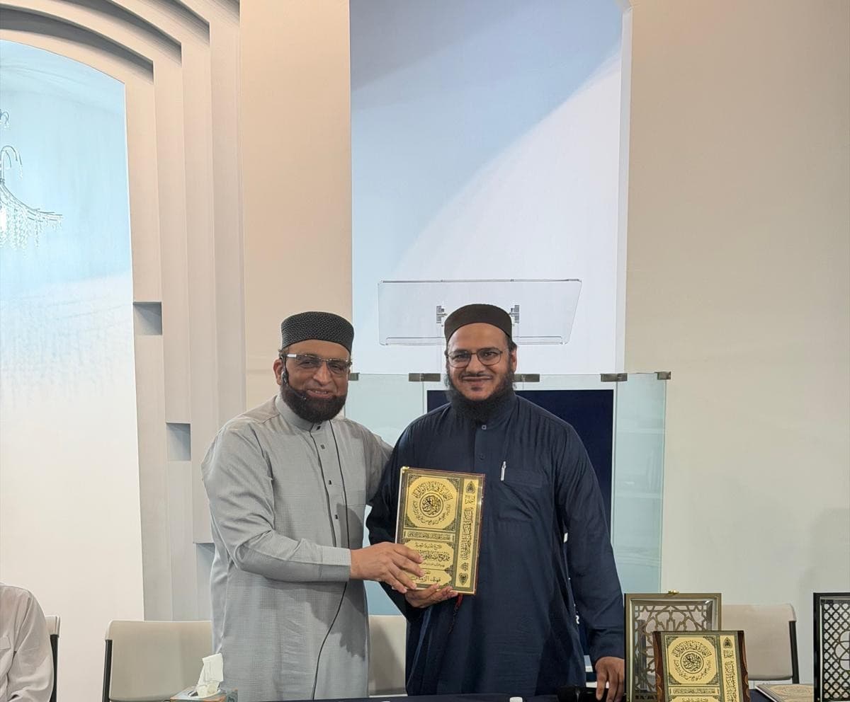 Dr. Shaykh Mamdouh conferring a certificate on a graduate.
